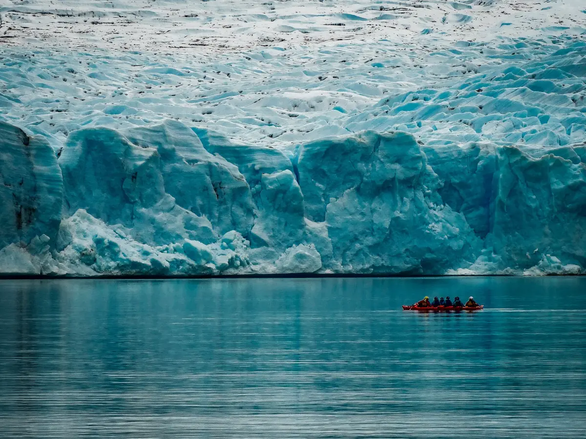 Kayaks in front of the Grey Glacier face